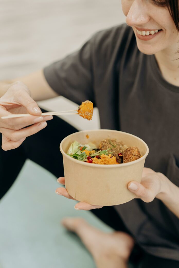 Young woman practicing mindful eating to make a healthier relationship with food